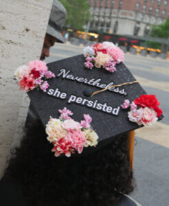 cap at graduation decorated with nevertheless she persisted