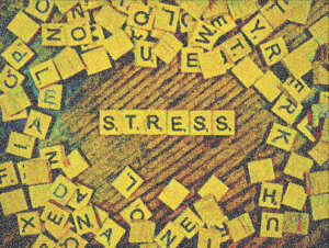 Scrabble stress tiles: Student struggle. focus on mental wellness, financial emergency,