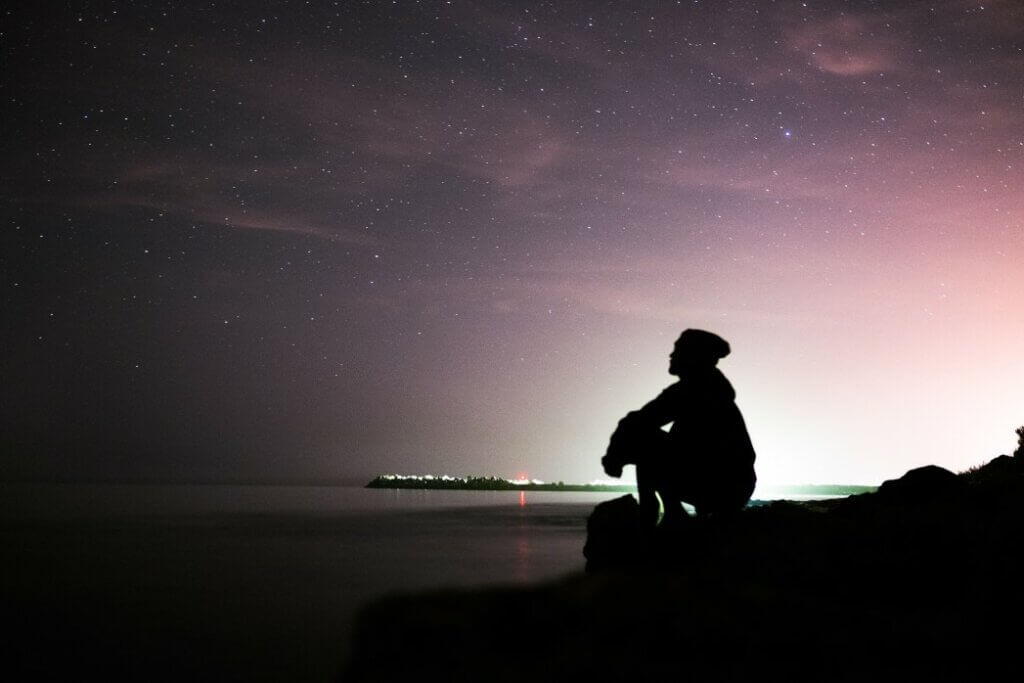 man sitting outside at night