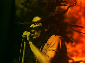 photo of bob marley singing into microphone