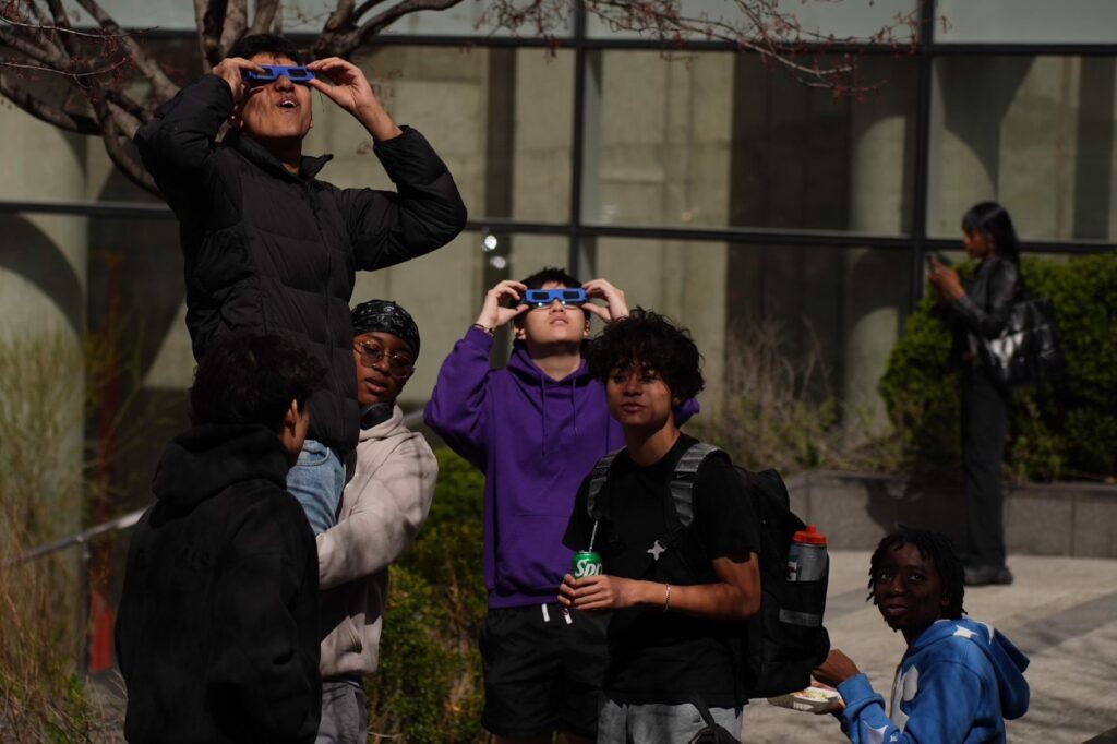 2nd place: United in wonder: New Yorkers pause, eyes skyward, to experience a collective moment of awe as sun and moon align for the 2024 eclipse. Photo: Latoya Duncan