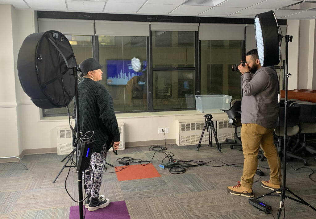 A student poses for a professional headshot during the in-person Welcome Back Reception.