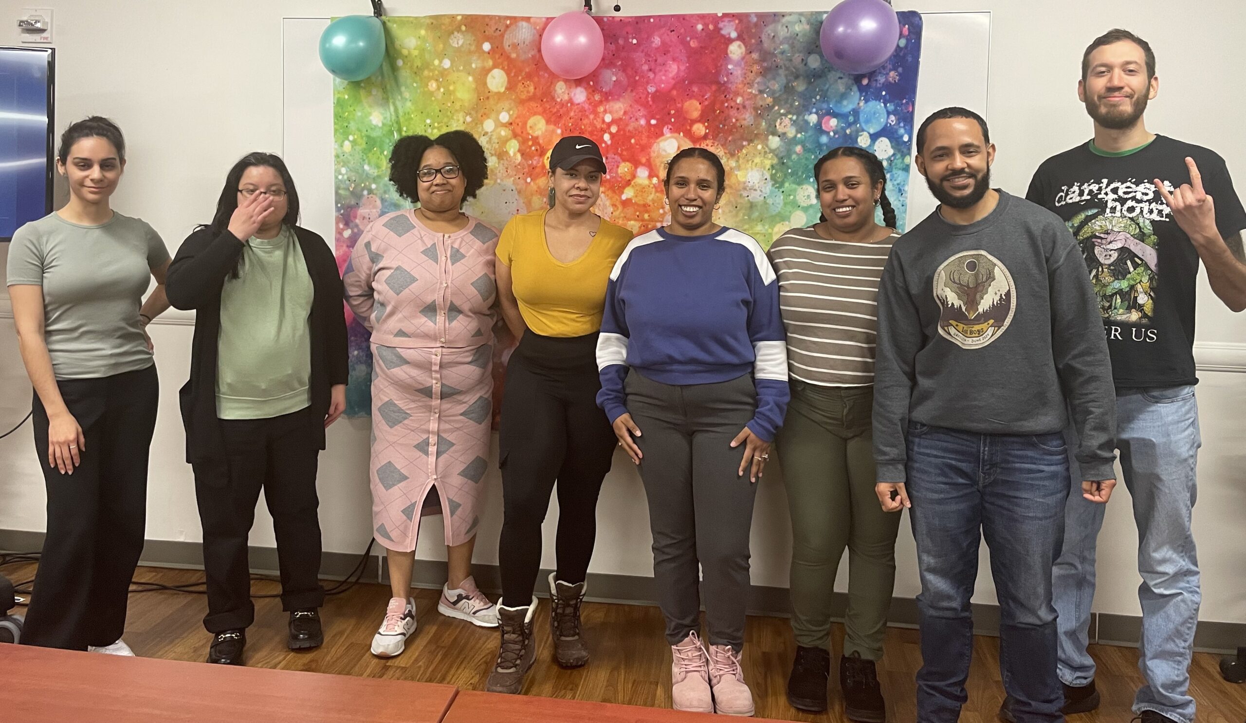 8 people standing next to each other at a Palentine's Day event