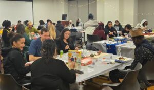 group of students sitting at tables talking
