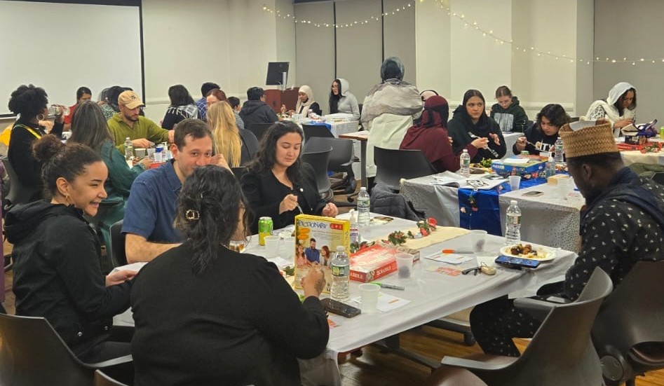 group of students sitting at tables talking