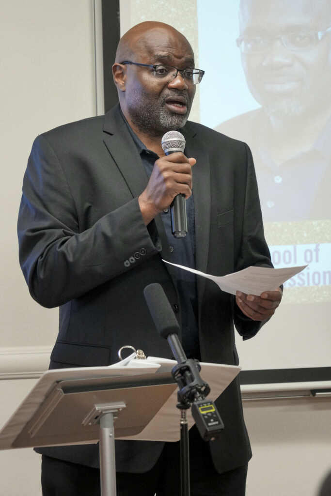 Professor James Richardson, former academic director of the Communication and Media program, addresses the crowd.